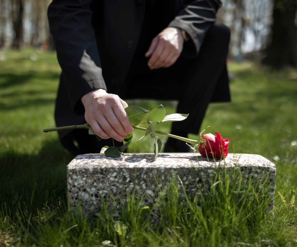 man-bringing-rose-tombstone-cemetery_11zon